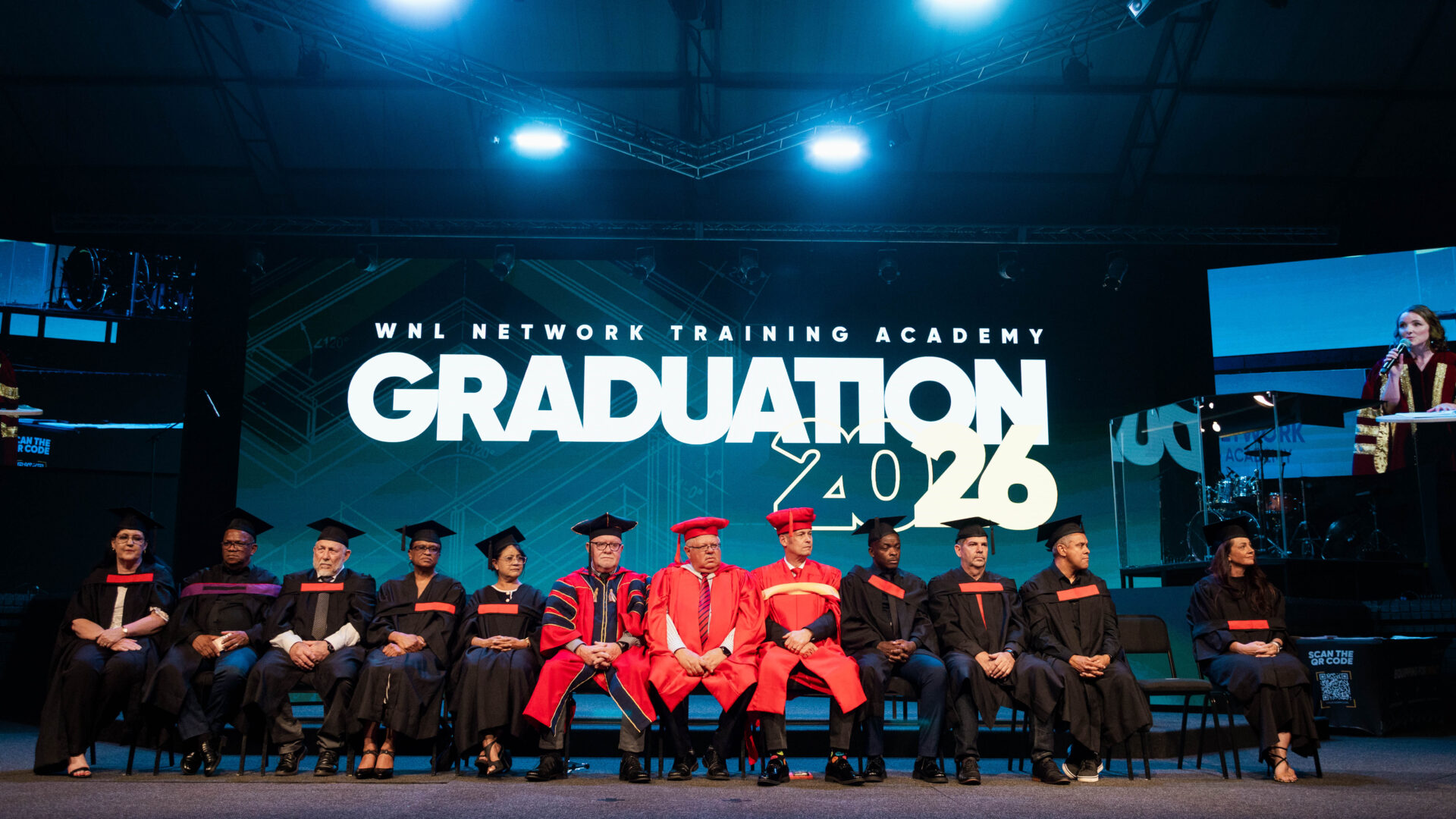 Academy leadership seated on stage at Graduation 2026