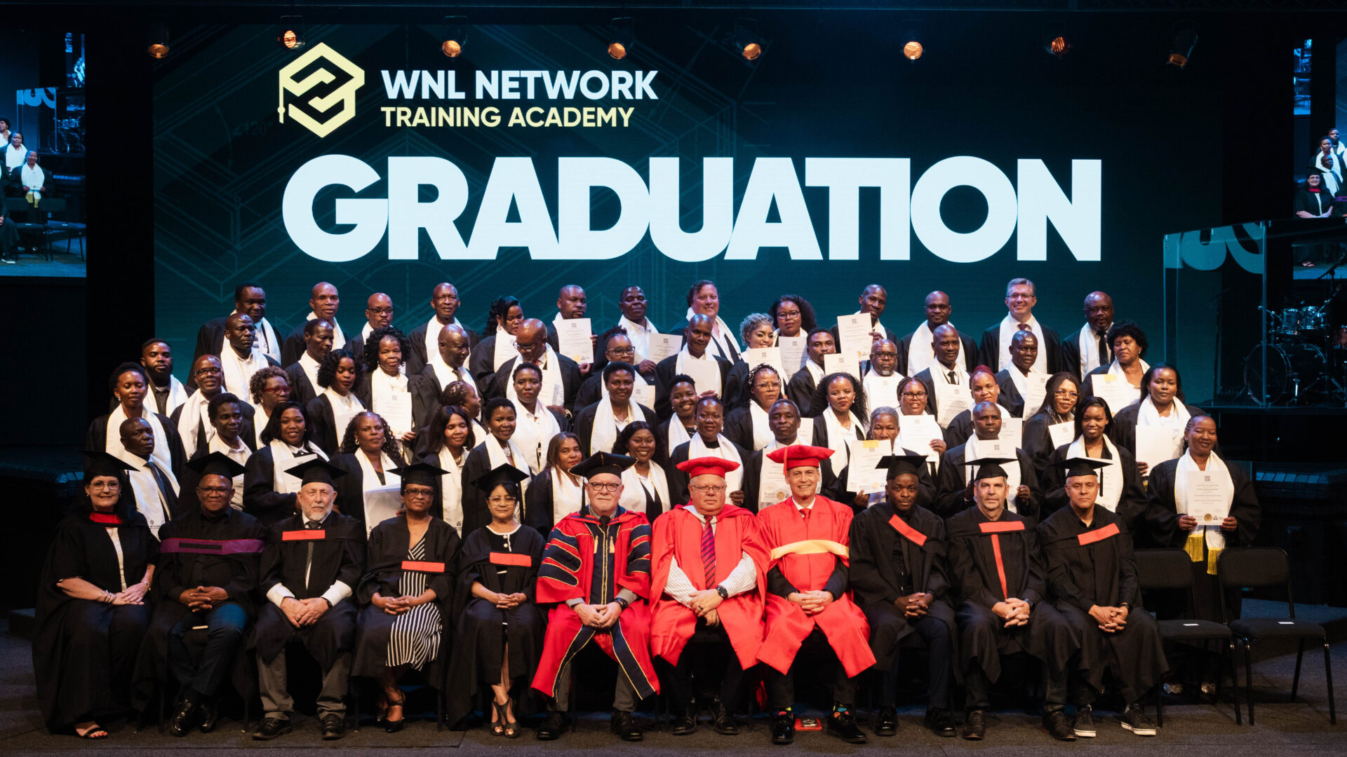 WNL Network Training Academy graduates and staff on stage at Graduation 2026